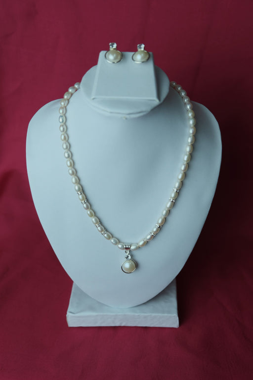 White color single line medium size fresh water cultured pearl necklace with pearl pendent along with jhumkas. LivySeller 
