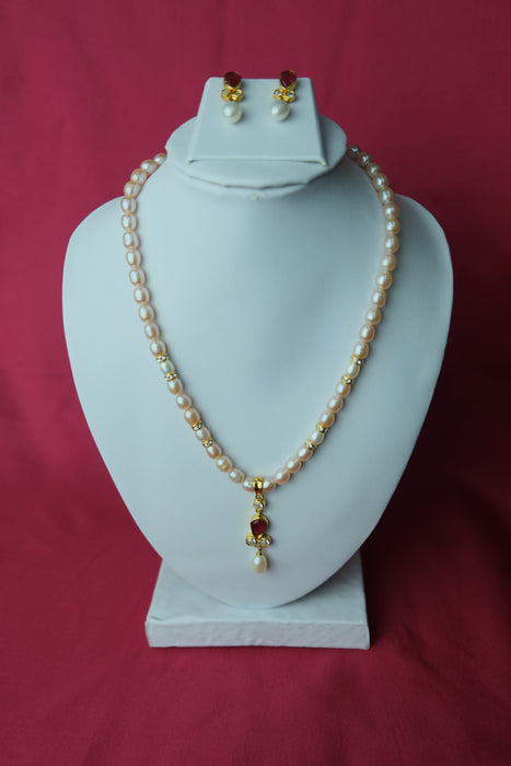 Cream color oval shape single line medium size fresh water cultured pearl necklace with pearl pendent along with jhumkas. LivySeller 